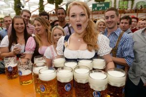epa03876883 Waitress Beli carries the first beer jugs during the opening of the 180th Oktoberfest at the Theresienwiese in Munich, Germany, 21 September 2013. The annual beer folk festival runs until 06 October. EPA/FELIX HOERHAGER